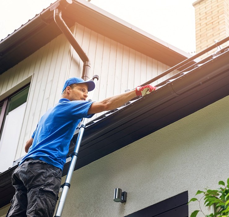Gutter contractor replacing gutters on house in Indianapolis
