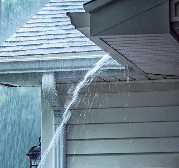 Heavy rain pooring off roof in Indiana